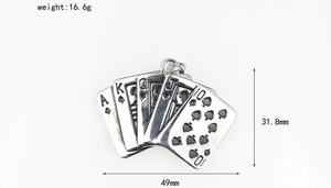Close-up of vintage titanium steel poker card pendant with detailed spade suit engraving