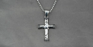 Detail view of gothic cross necklace with rock texture and black zircon stones inlay