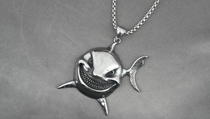 Macro shot of stainless steel shark pendant with black vintage oxidation details
