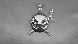 Macro shot of a polished shark head pendant with detailed teeth and large bail attachment