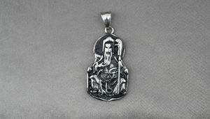 Detail view of vintage titanium steel Guan Yu pendant with antique silver finish carvings