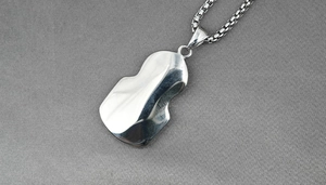 Detail of mirrored irregular wave pendant with liquid metal texture on box chain