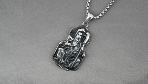 Macro shot of vintage stainless steel Guan Yu pendant with detailed box chain texture