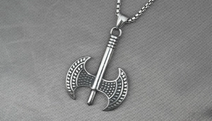 Close-up of vintage titanium steel double axe pendant with detailed box chain texture