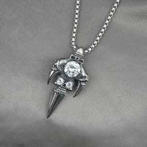 Punk style titanium steel skull pendant necklace with clear crystal on grey fabric