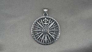 Macro detail of retro stainless steel nautical compass pendant with engraved numbers
