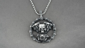 Macro view of engine pendant with skull and motorcycle chain details in steel