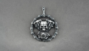 Detailed view of silver-tone skull V-engine pendant with biker chain punk design