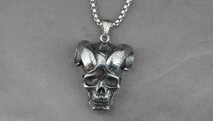 Detailed close-up of retro ram skull pendant in vintage blackened stainless steel