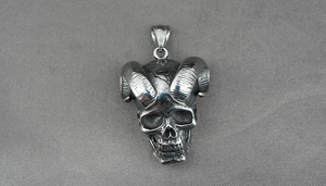 Detailed view of a gothic ram skull pendant made of polished vintage stainless steel
