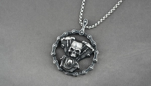 Macro shot of a punk skull engine pendant with motorcycle chain border and box chain