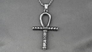 Close-up of vintage Ankh cross pendant with Eye of Horus in matte steel finish