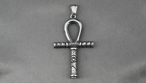 Detailed close-up of vintage Ankh cross pendant with Eye of Horus symbol and hammer texture