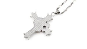 Detailed view of silver cross pendant with unique mesh texture and vintage steel finish