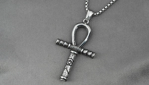 Close-up of vintage silver Ankh cross pendant with Eye of Horus detail on chain
