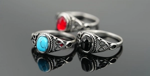 Macro shot of vintage titanium steel rings with turquoise, onyx, and ruby gemstones