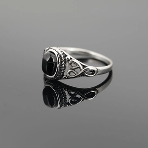 Retro stainless steel ring for men featuring a black oval gemstone and vintage carvings