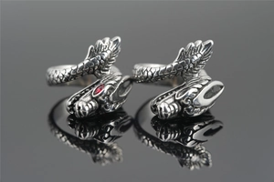 Detail of vintage dragon rings with intricate scales and a single red gemstone eye