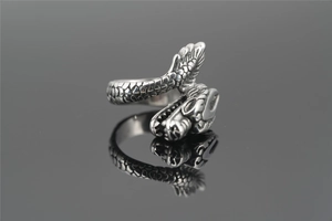 Macro shot of a vintage silver dragon head ring with detailed scales and spiral design