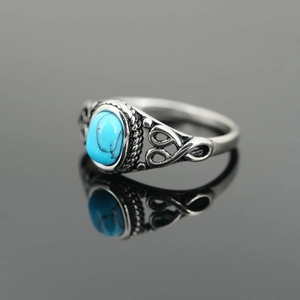 Vintage titanium steel ring featuring an oval turquoise stone and boho hollow patterns