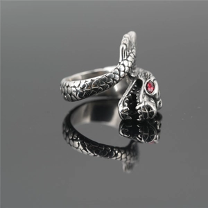Retro dragon head ring in silver stainless steel with red gem eyes on black mirror surface
