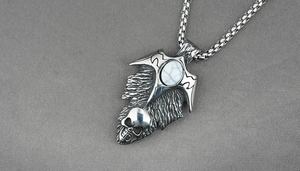 Macro detail of gothic turquoise skull pendant with arrow shape on vintage metal chain