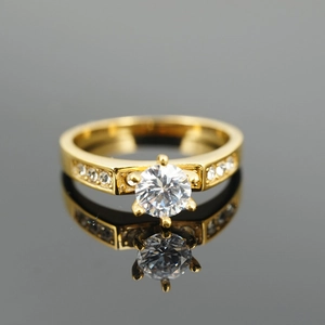 Classic gold titanium steel engagement ring featuring a large round center diamond and accents