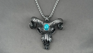 Macro detail of vintage skull pendant with blue turquoise stone and box chain