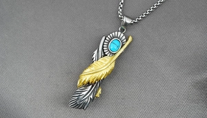 Detail of vintage turquoise and double feather pendant on a steel box chain necklace