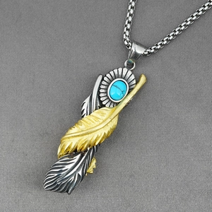 Vintage turquoise feather pendant necklace with gold and silver details on box chain