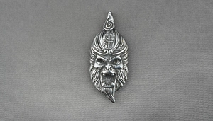 Macro detail of vintage Sun Wukong stainless steel pendant with intricate facial carvings