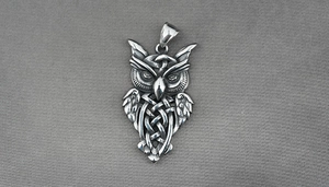 Detailed close-up of retro silver owl pendant featuring intricate Celtic knot patterns