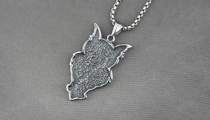 Macro shot of titanium steel owl necklace featuring vintage textured industrial pendant