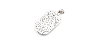 Detailed macro view of the silver rectangle pendant with eagle eye and bear patterns