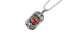 Macro view of vintage silver steel eagle pendant with red stone and box chain detail