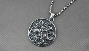 Detailed relief of a griffin on a vintage silver steel pendant with box chain