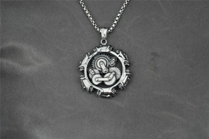 Close-up of steampunk engine gear pendant on a box chain with detailed metal gears