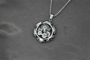 Detailed macro view of a steampunk gear engine pendant with a vintage silver box chain