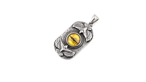 Detail of vintage double eagle pendant with yellow eye stone on stainless steel necklace