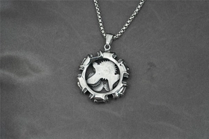 Macro shot of mechanical gear pendant in vintage silver steel with a round box chain