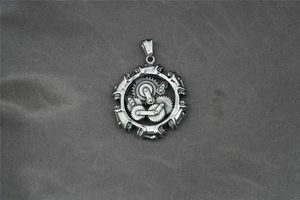 Detail of a steampunk mechanical gear pendant in silver metal with industrial wheel design