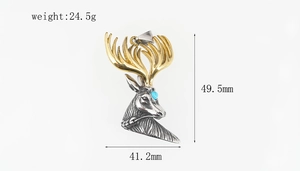 Macro detail of bicolored stag head pendant with turquoise stone and golden antlers