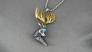 Detailed macro view of bicolor titanium steel deer head pendant with blue stone inlay