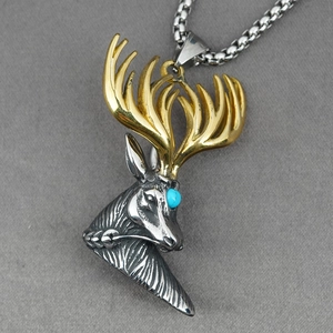Vintage stag head pendant necklace with turquoise eye and gold antlers on steel chain