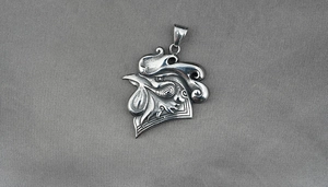 Detailed close-up of a 3D rooster pendant crafted from embossed stainless steel metal