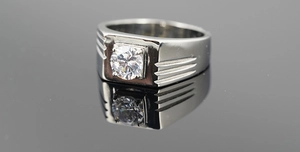 Macro detail of men's titanium steel ring featuring a round cut zircon and carved side lines