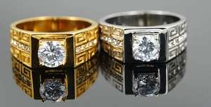 Detail view of gold and silver titanium rings featuring Greca patterns and round zircon