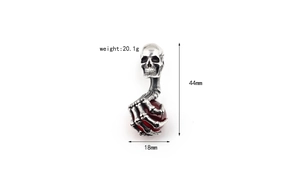 Macro detail of gothic skull pendant with red stone, measuring 44mm in height