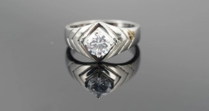 Detail of titanium steel ring with square cut diamond and V-shaped side engraving