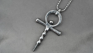 Macro shot of silver Ankh cross pendant with hammered texture and sturdy box chain